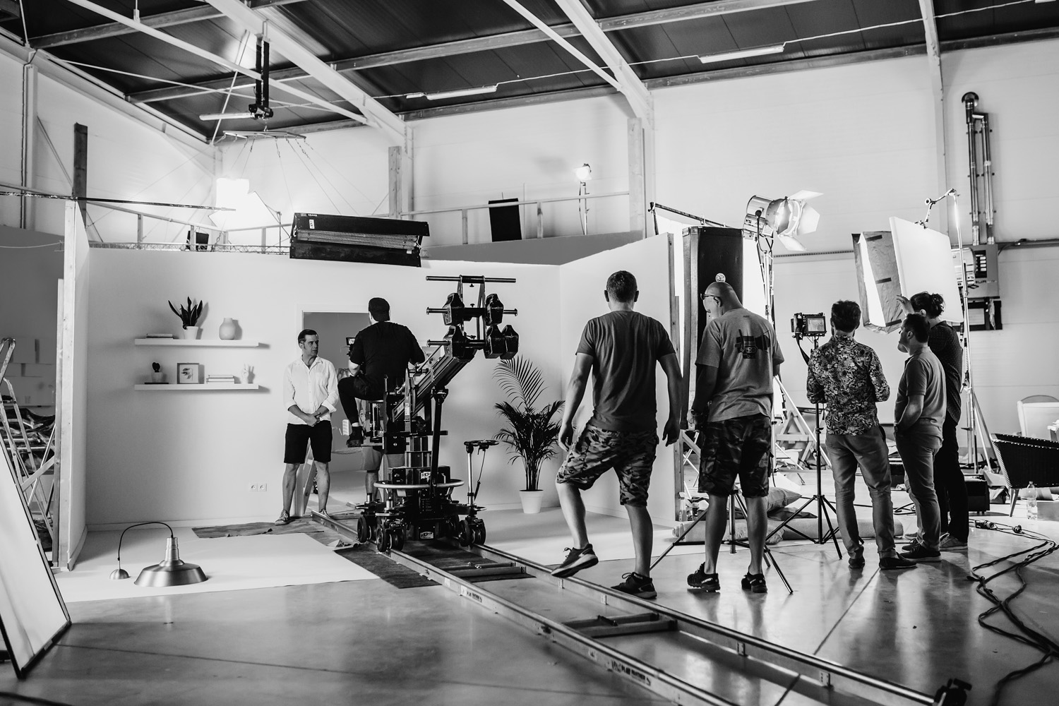 Film set at sunrise with crew and lighting rigs